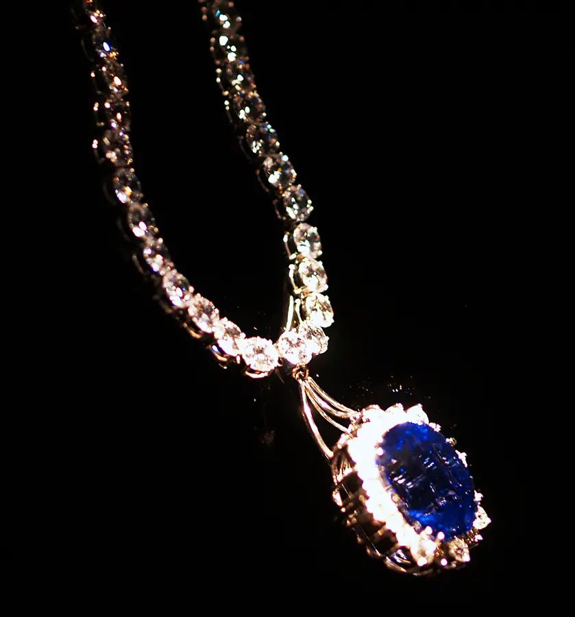 A blue sapphire pendant on a diamond set chain