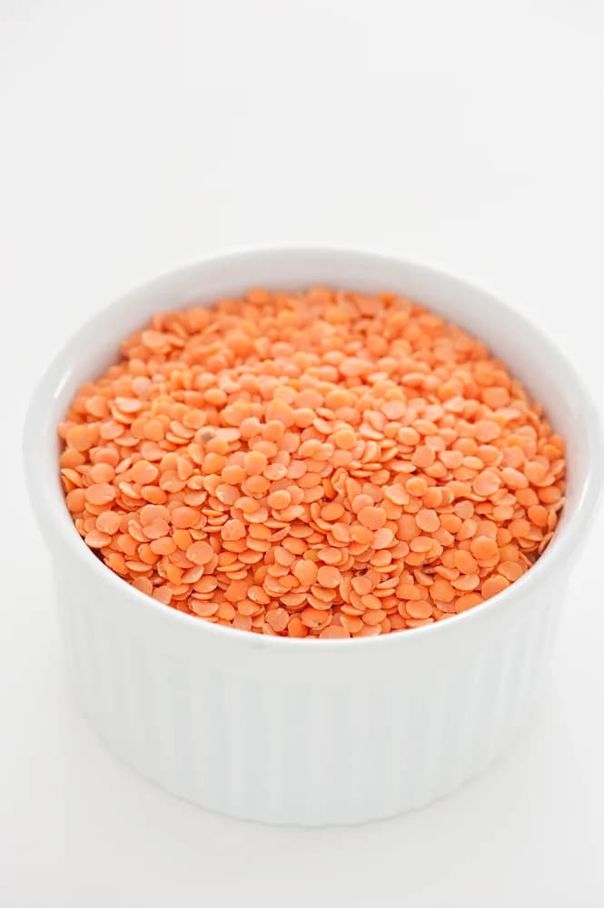 Split red lentils in a white dish